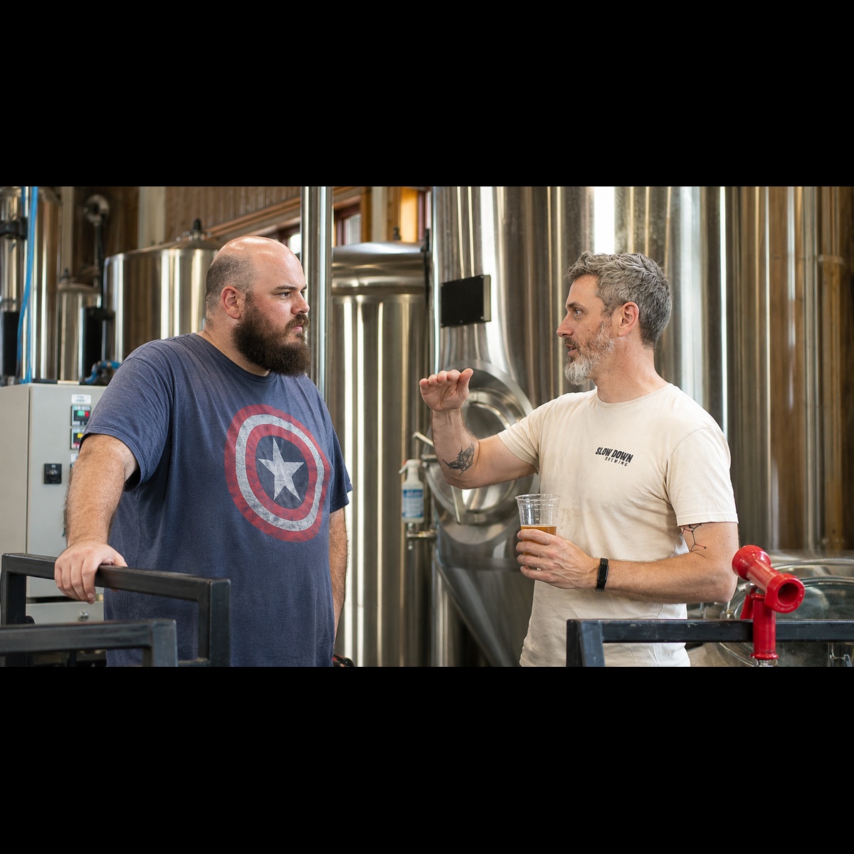 Jonathan and Aaron talking by the fermenters